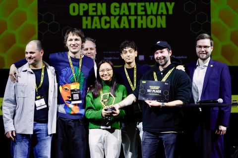 Nokia representatives, Lauri Alho and Mikko Jarva, and winners on stage at the GSMA Open Gateway Hackathon, celebrating advancements in Network APIs and AI-assisted coding for programmable networks.