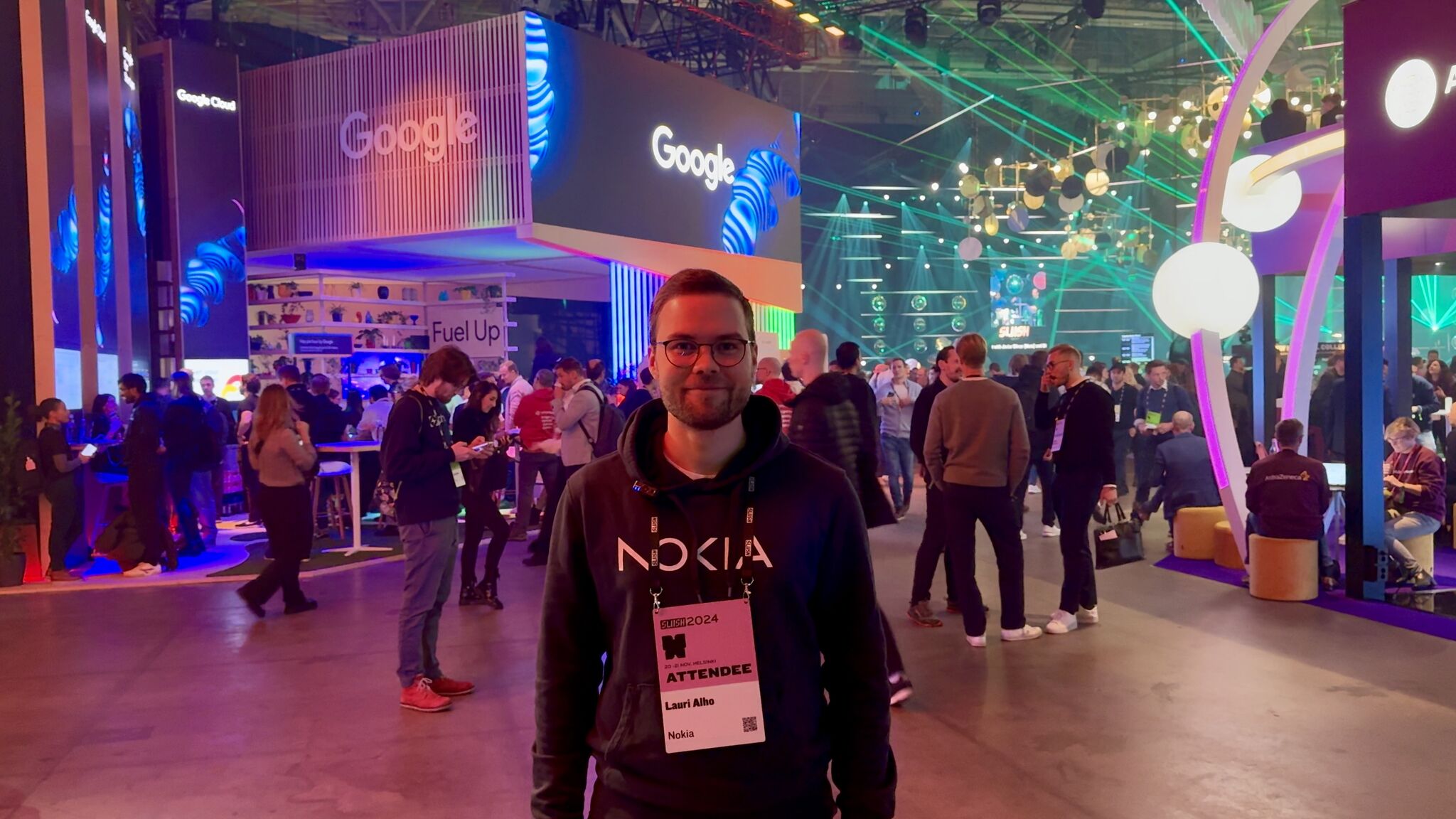 Lauri Alho, a Nokia attendee at Slush 2024, stands in front of the Google booth, representing Nokia's participation in discussions on AI and its telco use cases.