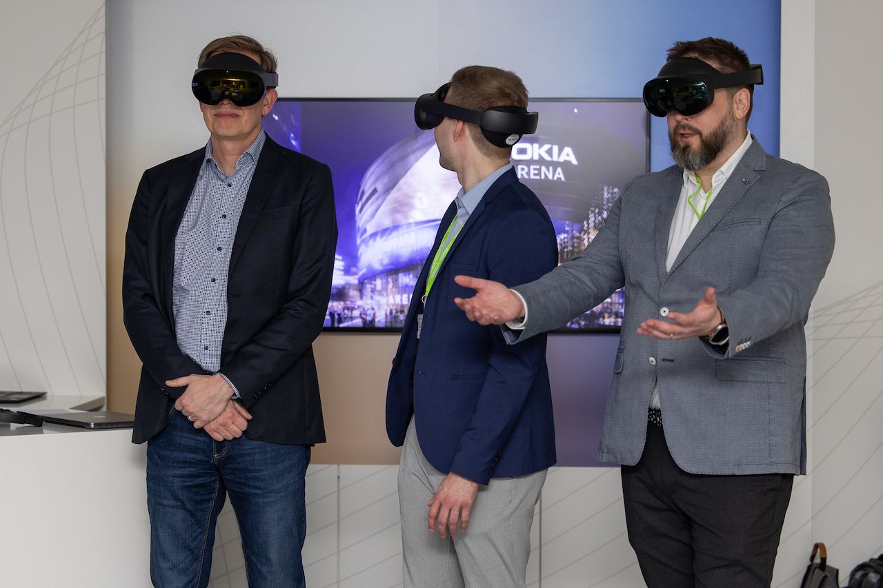Lauri Alho and two other professionals experiencing the Andrea Bocelli virtual concert from Nokia Arena at Elisa Showroom, Helsinki, Finland, using 5G and VR technology.