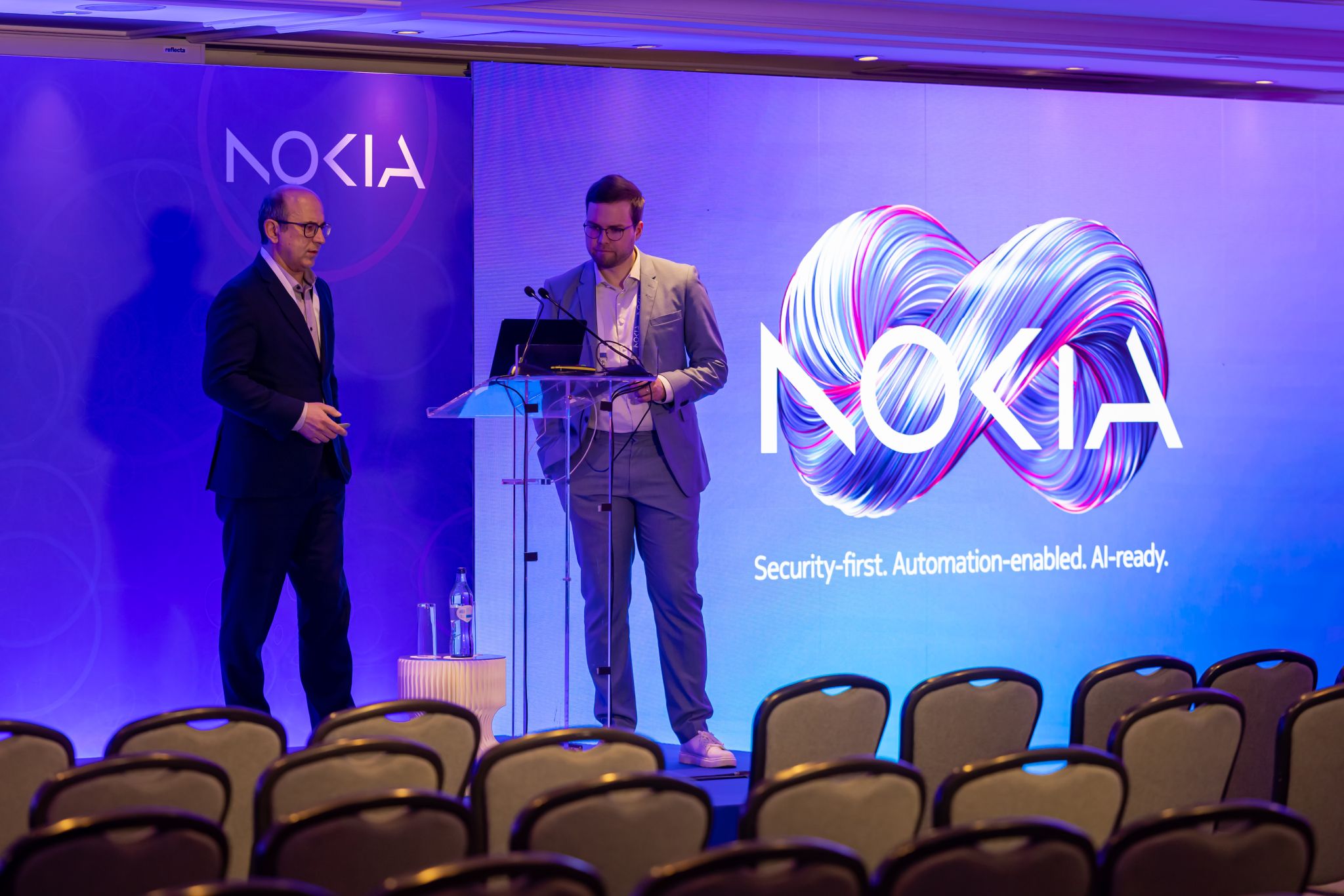 Lauri Alho and Shkumbin Hamiti, VP Network Monetization Platform at Nokia, preapring a Core User Group 2025 presentation on Network as Code and API solutions for security and fraud detection, including Google Gemini AI applications, with Nokia's 'Security-first. Automation-enabled. AI-ready.' branding.