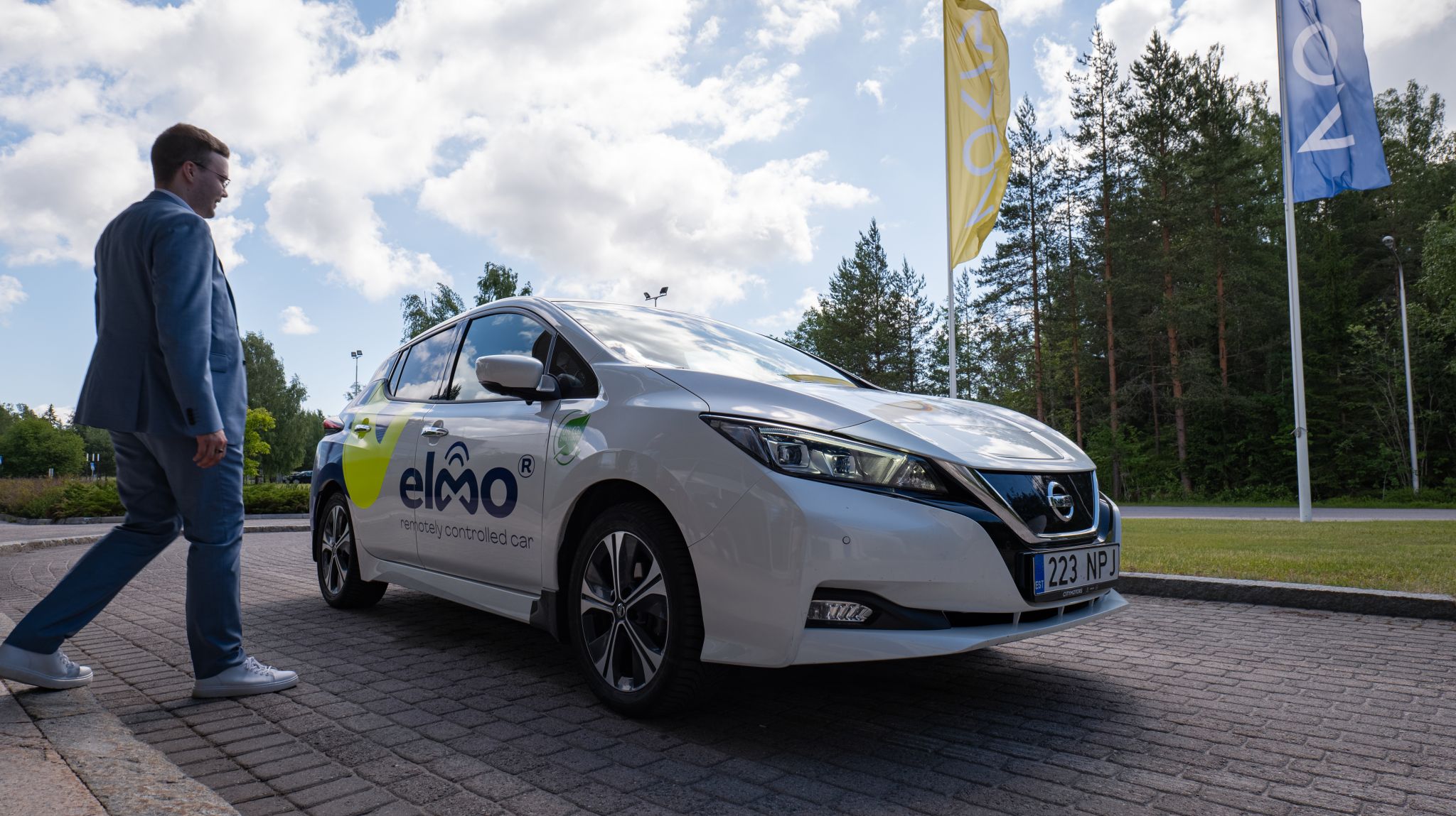 Lauri Alho walking towards the Elmo remotely controlled car used for a live demonstration at Nokia Core User Group 2024, showcasing Nokia Network as Code over the Elisa 5G network.