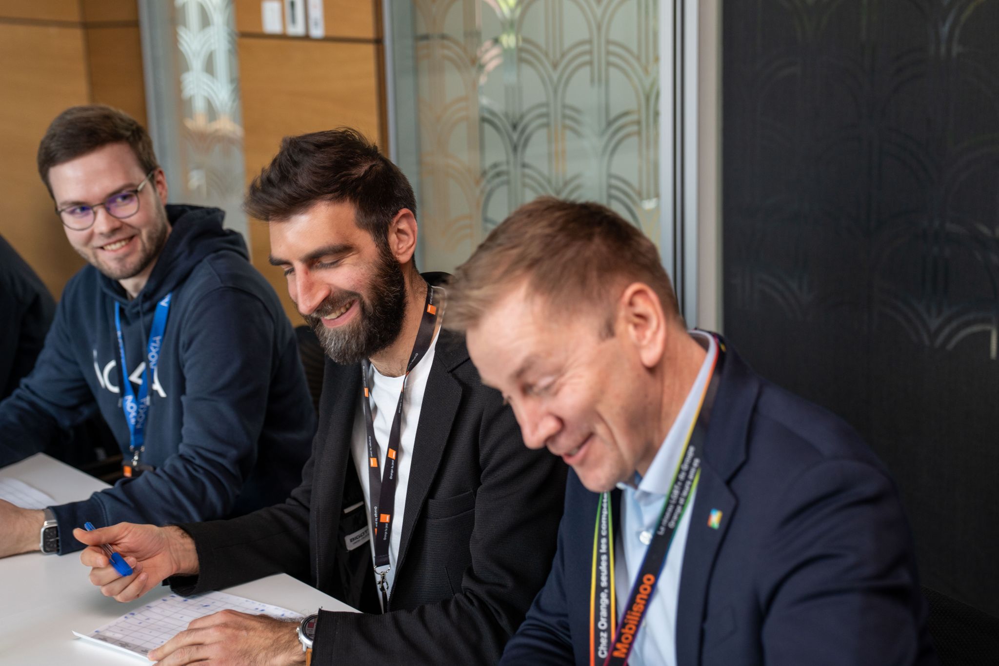 Lauri Alho from Nokia and two other judges, judging the Orange Camara API Hackathon in Warsaw, showcasing Camara APIs and Network as Code.