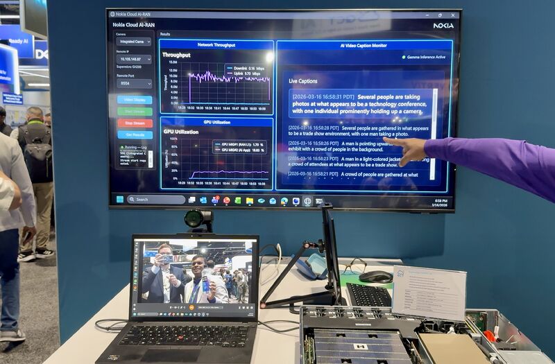 Lauri Alho seen in a webcam footage taking a picture of a Nokia Cloud AI-RAN live demo at NVIDIA GTC San Jose, displaying real-time network throughput, GPU utilization, and AI video captioning. This showcases the integration of physical AI applications on AI-RAN-ready infrastructure, a key aspect of the Nokia, NVIDIA, and T-Mobile collaboration for distributed edge AI computing.