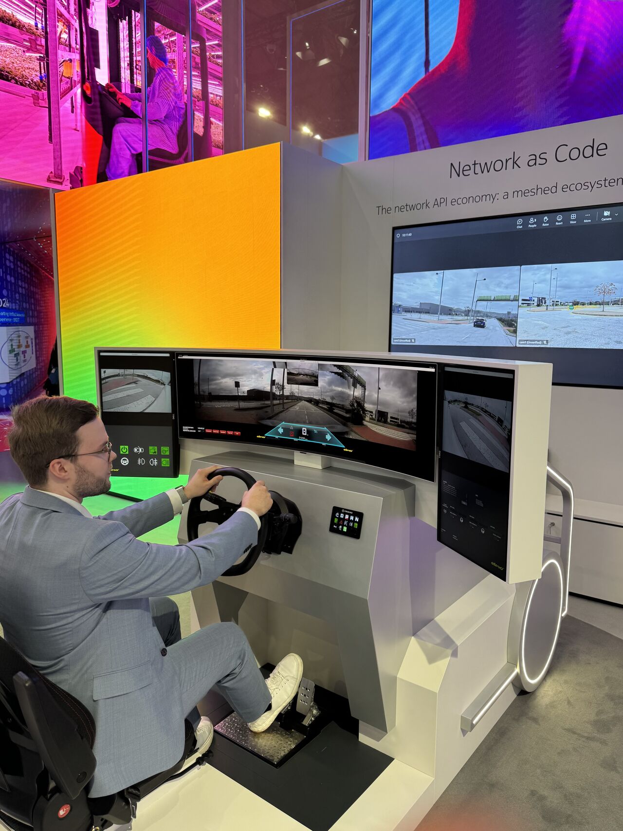 Lauri Alho operates an Elmo teledriving station at MWC, showcasing Network as Code and the network API economy for live remote driving demonstrations at Nokia and GSMA booths.