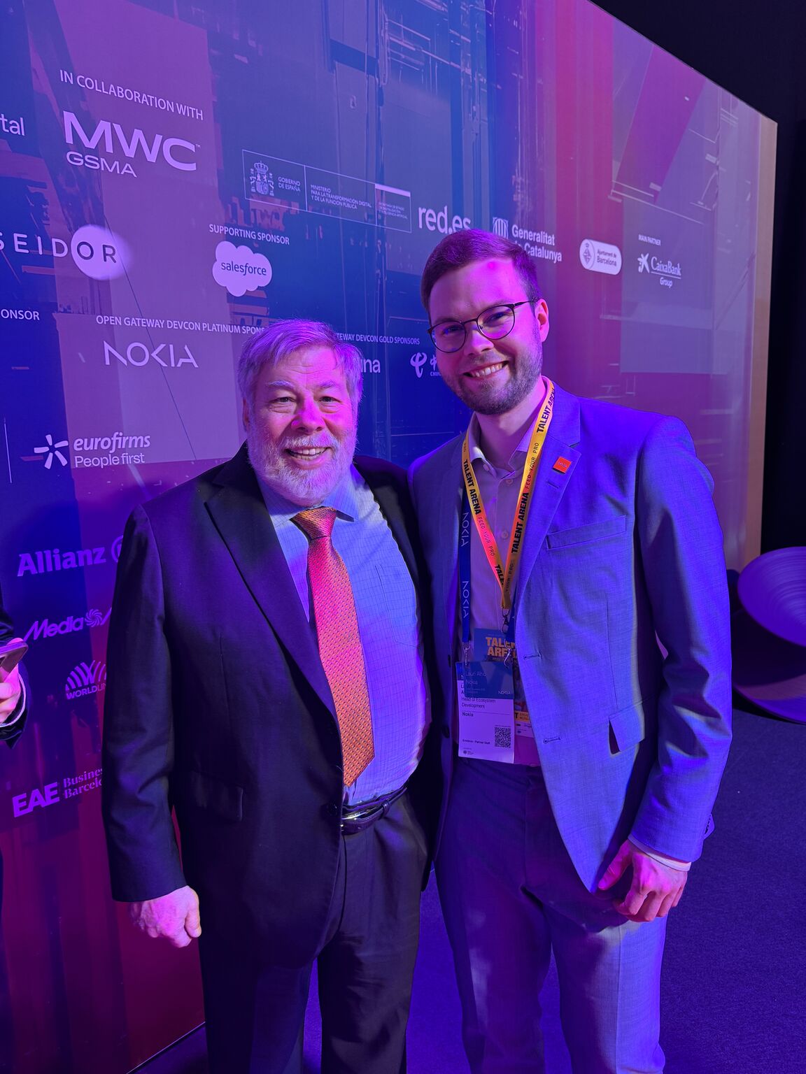 Steve Wozniak with Lauri Alho, Head of Ecosystem Development at Nokia, during MWC. The event backdrop features MWC and Nokia branding.