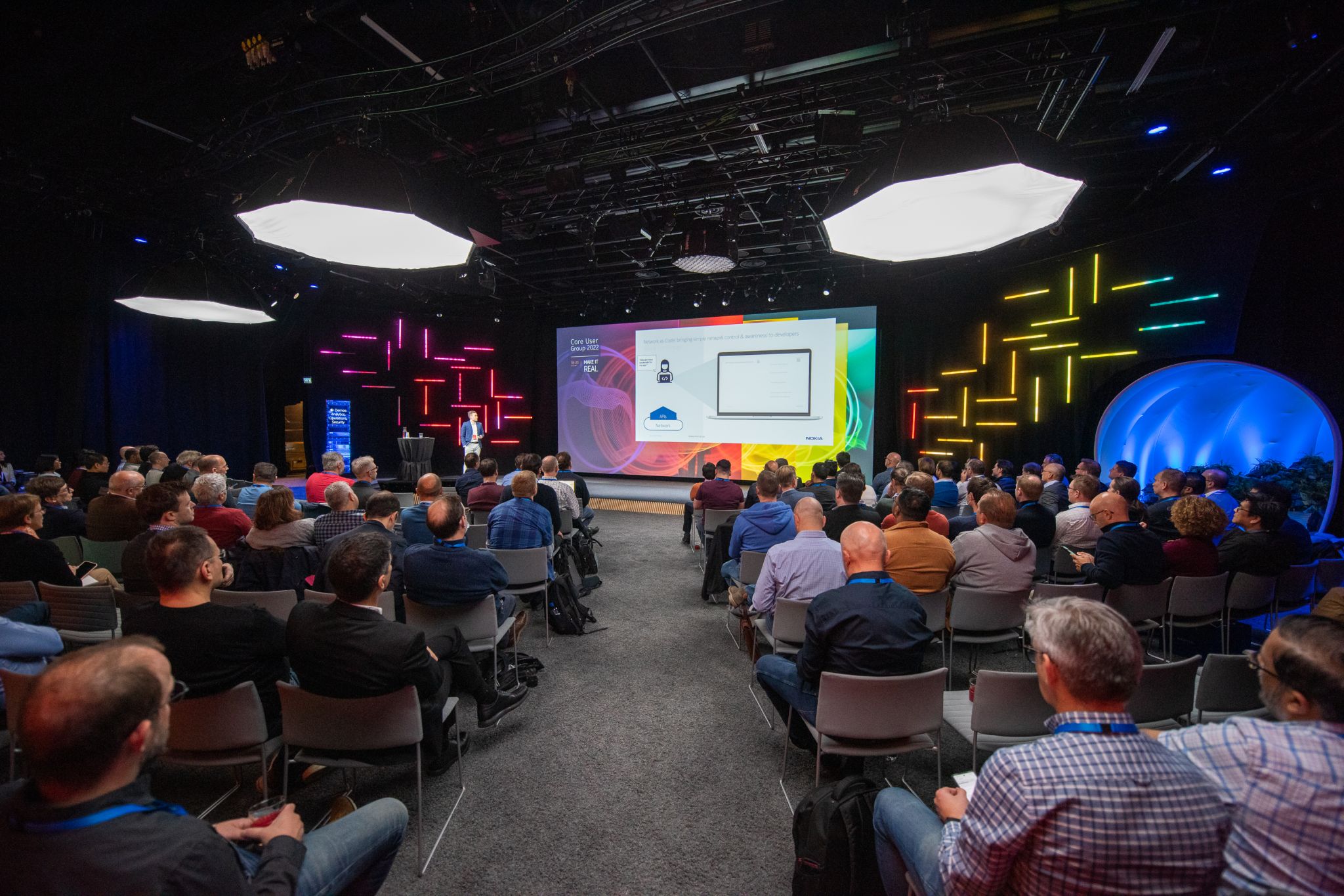 Lauri Alho presenting the Nokia Network as Code platform to an audience at a Nokia Core User Group 2022 event, highlighting network programmability and monetization.